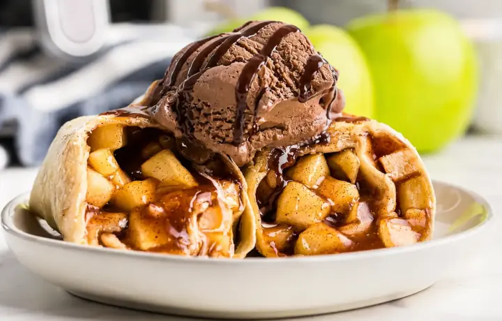 Freshly fried apple Miniella Apple Rolls with caramel drizzle and ice cream